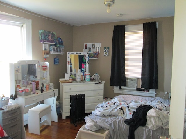 bedroom featuring cooling unit and dark hardwood / wood-style floors