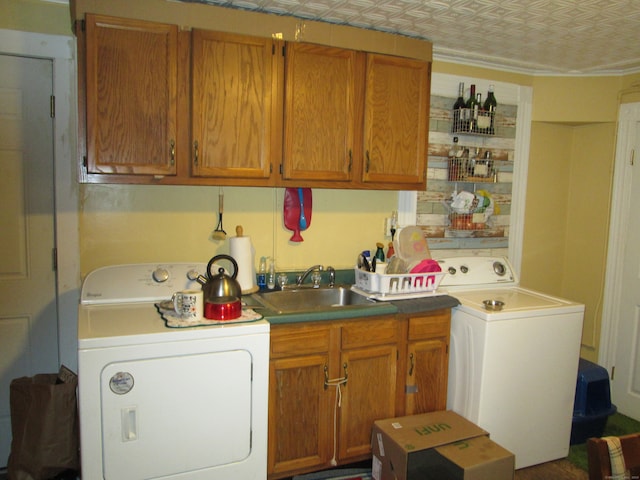 laundry area with washer / dryer, sink, and cabinets