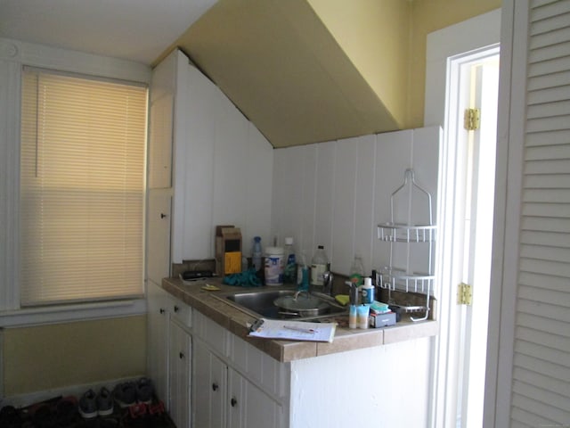 kitchen with white cabinetry and sink