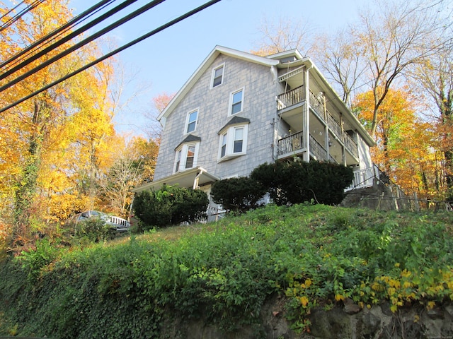 view of side of home featuring a balcony