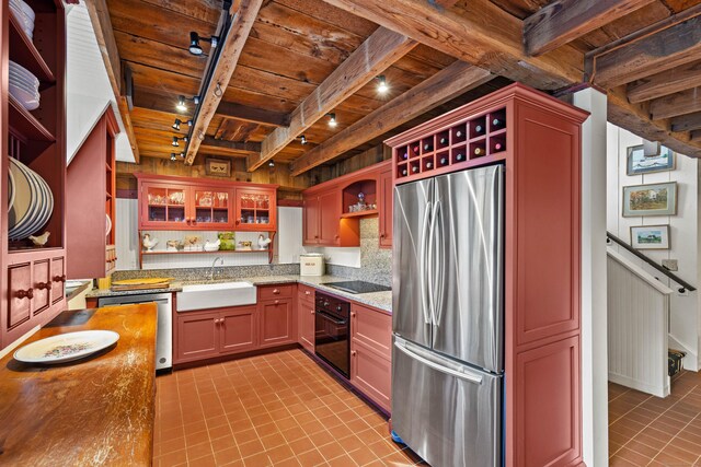 kitchen featuring sink, wood ceiling, rail lighting, beam ceiling, and black appliances