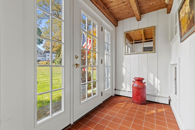 doorway to outside with baseboard heating, wooden ceiling, beam ceiling, and tile patterned floors