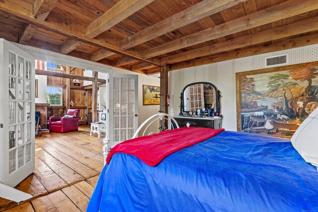 bedroom with french doors, beam ceiling, light hardwood / wood-style flooring, and wooden ceiling