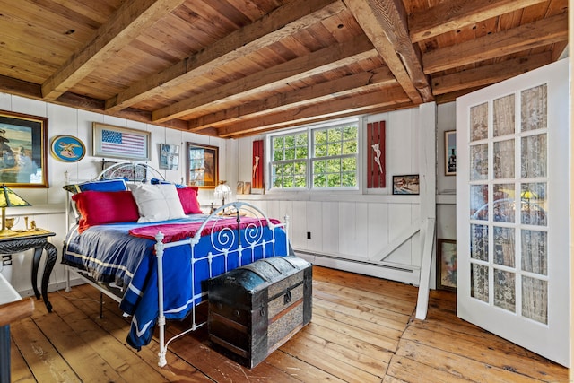 bedroom with wood ceiling, light hardwood / wood-style floors, and a baseboard heating unit