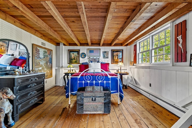 bedroom with beamed ceiling, wood ceiling, light hardwood / wood-style floors, and a baseboard heating unit