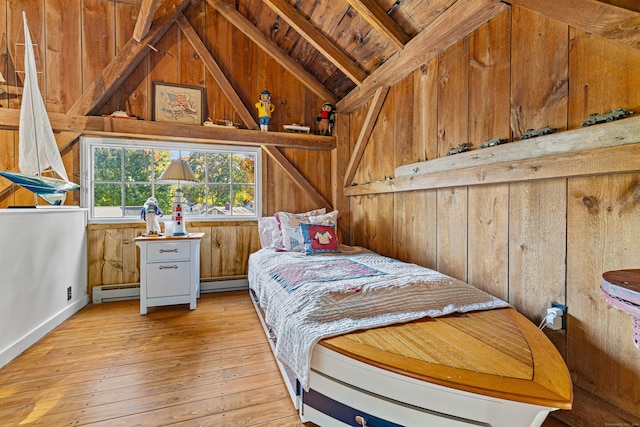 bedroom with lofted ceiling with beams, wooden ceiling, light wood-style flooring, baseboard heating, and wood walls