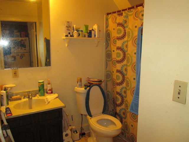 bathroom featuring toilet, walk in shower, and vanity