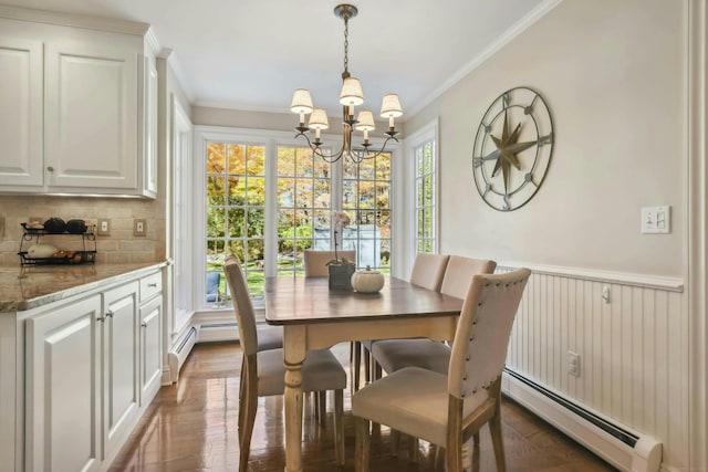 dining room with a wainscoted wall, a baseboard radiator, ornamental molding, and dark wood finished floors