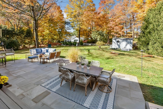 view of patio / terrace with an outbuilding, outdoor lounge area, outdoor dining space, and a shed