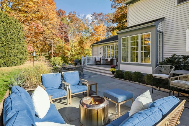 view of patio / terrace featuring an outdoor living space with a fire pit