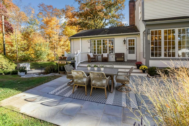 view of patio with outdoor dining area and grilling area