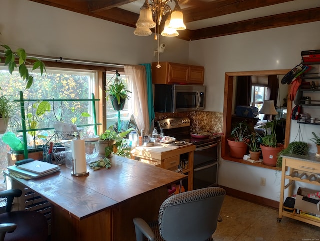 kitchen with beam ceiling, tasteful backsplash, appliances with stainless steel finishes, and light tile patterned flooring