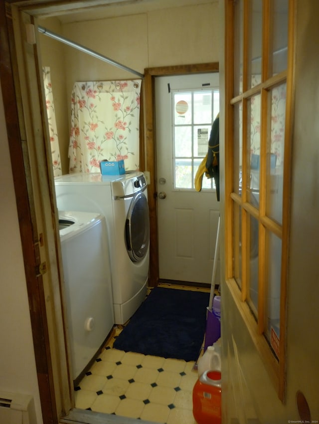 clothes washing area with washer and clothes dryer