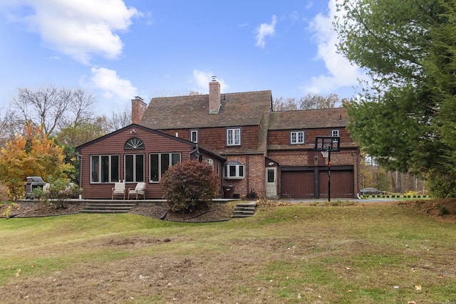 back of house with a lawn