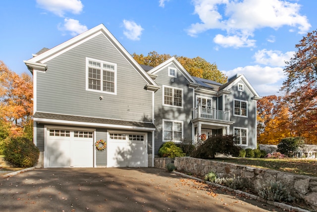 view of front of house featuring a balcony and a garage