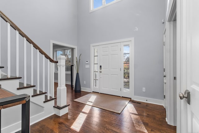 entrance foyer featuring dark wood-type flooring and a high ceiling