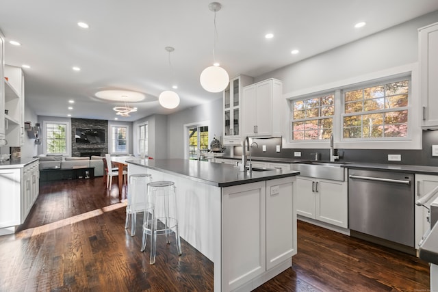 kitchen with dishwasher, a wealth of natural light, and white cabinets