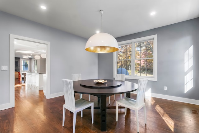 dining space featuring dark hardwood / wood-style flooring