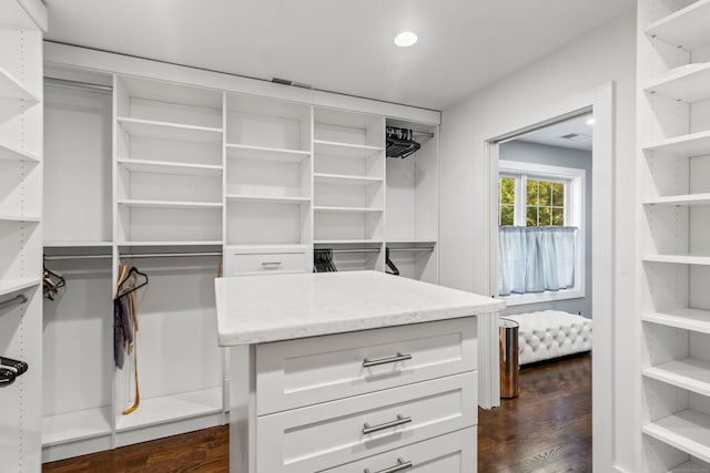 walk in closet with dark hardwood / wood-style floors