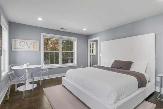 bedroom with dark hardwood / wood-style flooring