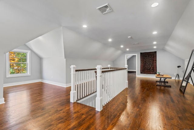 bonus room with vaulted ceiling and dark hardwood / wood-style flooring