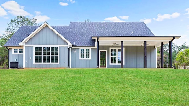 back of house with a lawn and ceiling fan