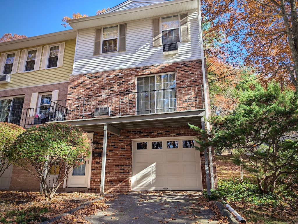 view of front of property with cooling unit and a garage