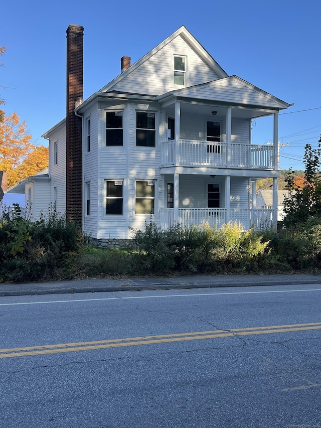 509 S Main St, Torrington, CT 06790 - neoclassical home featuring a chimney, covered porch, and a balcony