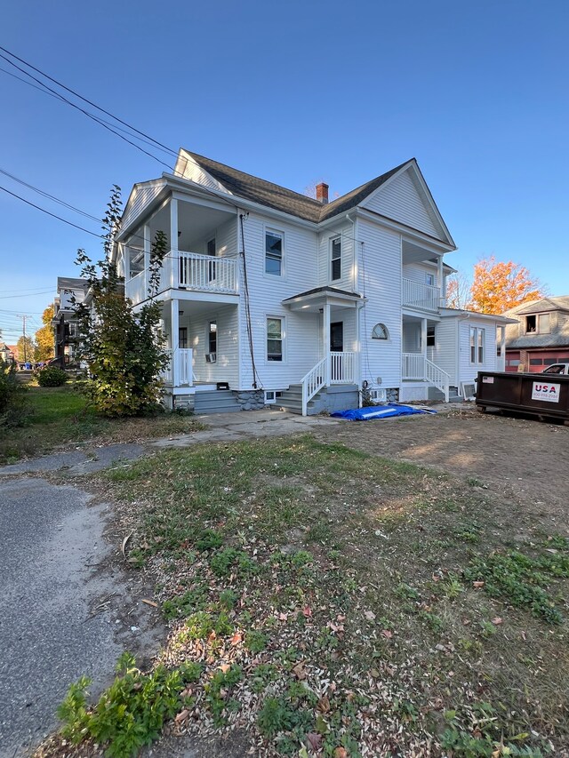 back of property featuring a balcony