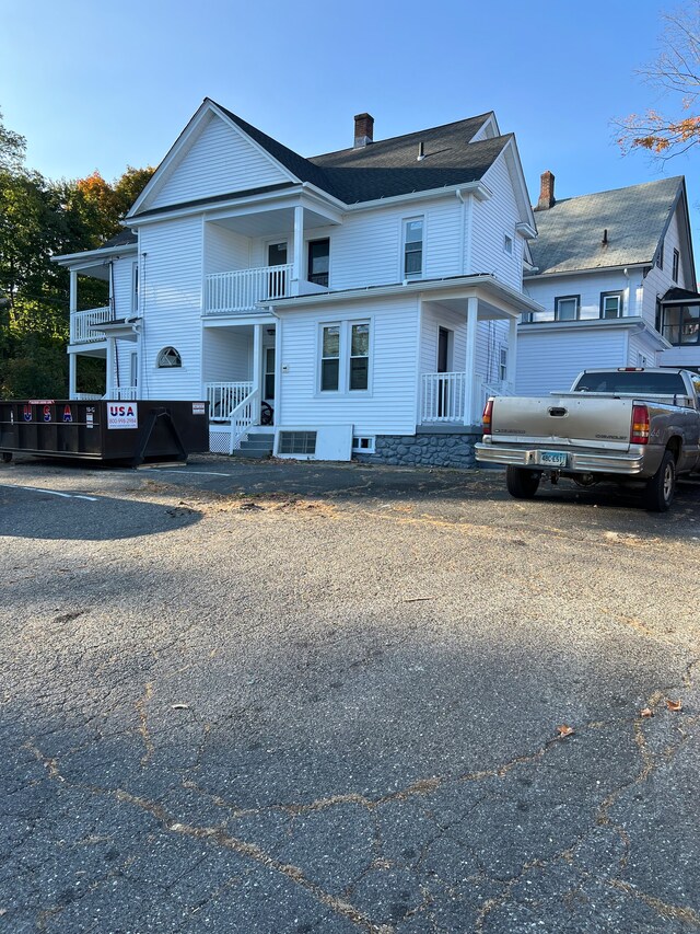 view of front of house with a porch and a balcony