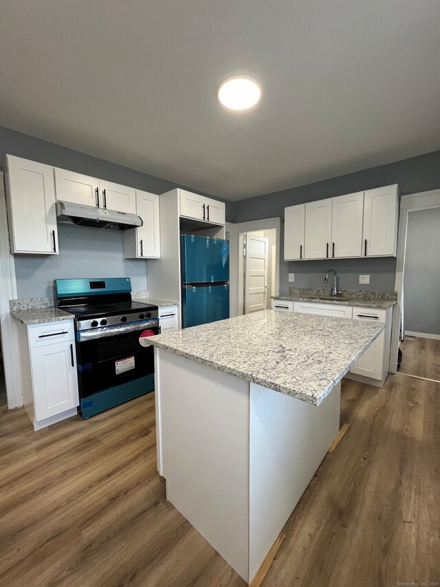 kitchen with a kitchen island, white cabinetry, fridge, dark hardwood / wood-style floors, and black electric range