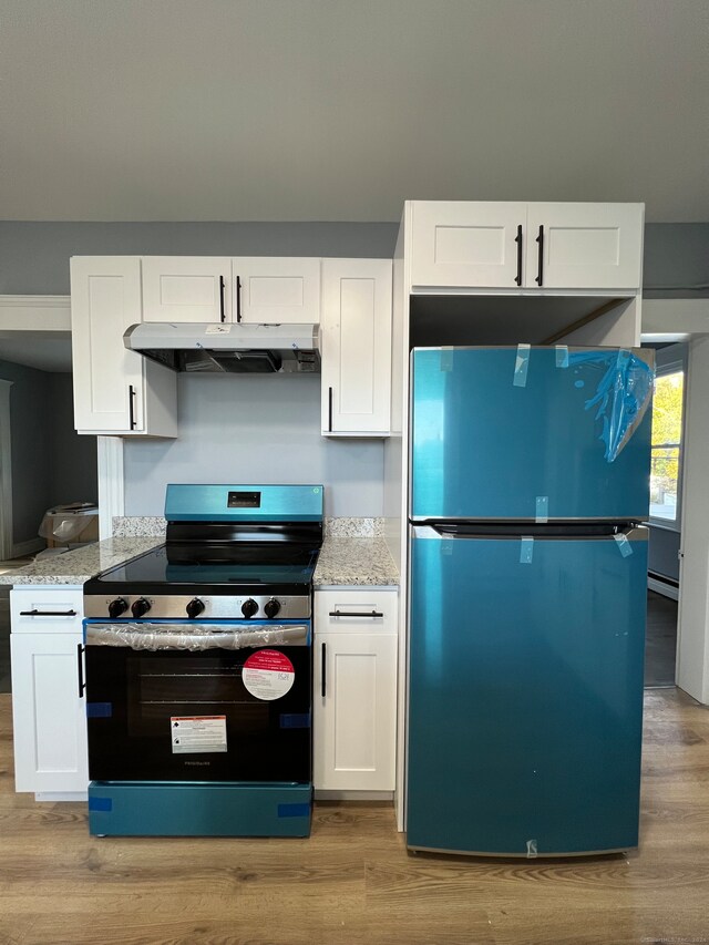 kitchen featuring white cabinets, refrigerator, light hardwood / wood-style flooring, and stainless steel range with electric cooktop