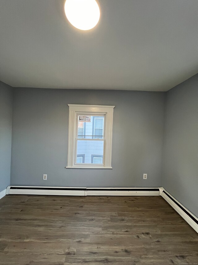 spare room featuring dark hardwood / wood-style flooring