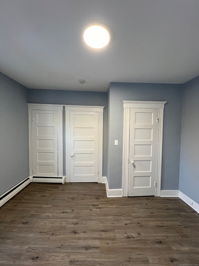 corridor with dark hardwood / wood-style floors