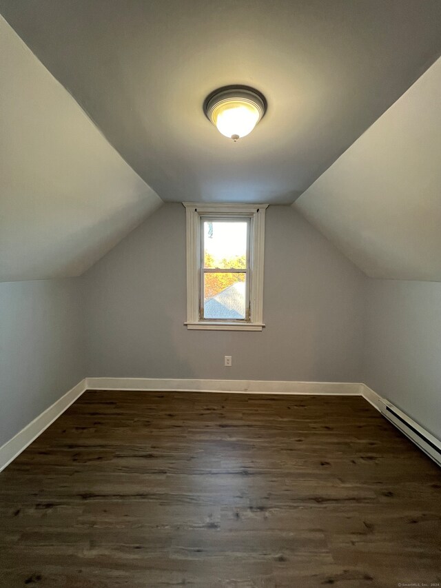 additional living space with lofted ceiling and dark wood-type flooring