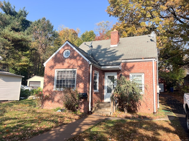 view of front of home featuring a garage and an outdoor structure