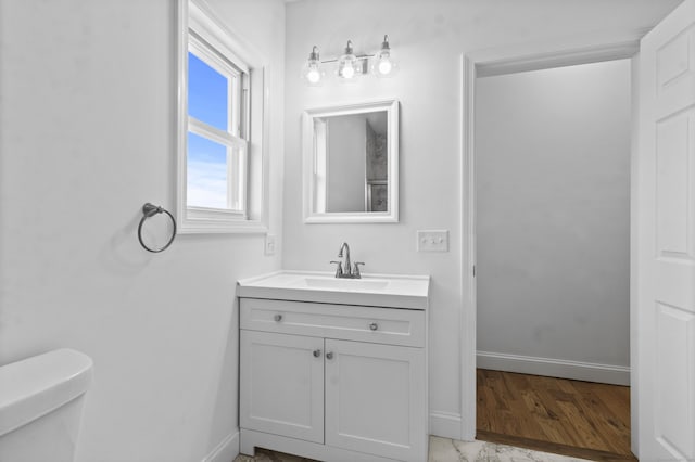 bathroom featuring vanity and toilet