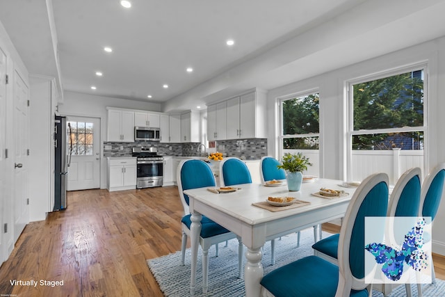 dining room featuring plenty of natural light, light hardwood / wood-style floors, and sink