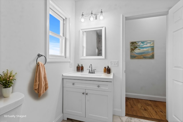 bathroom featuring vanity and toilet