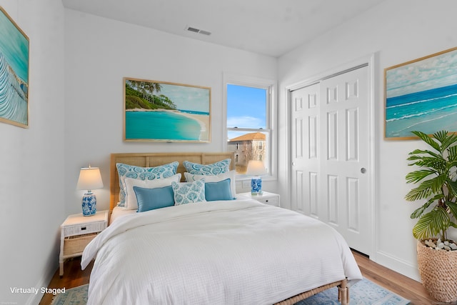 bedroom with a closet and hardwood / wood-style flooring