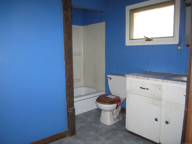 bathroom with vanity, toilet, and a washtub