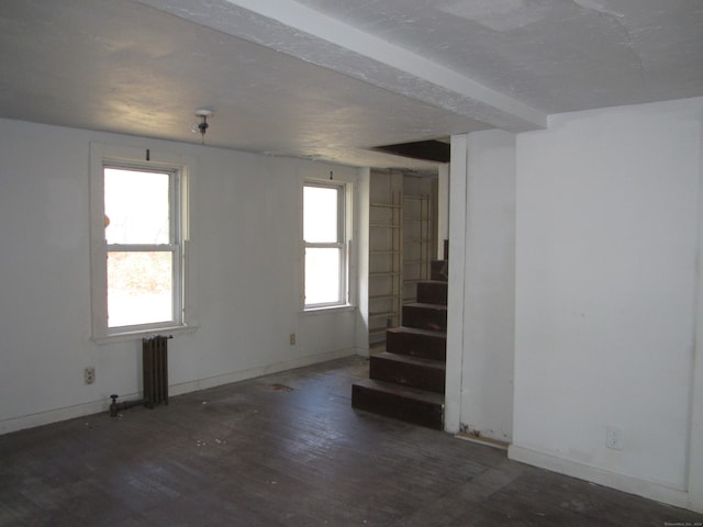 basement featuring radiator and dark wood-type flooring