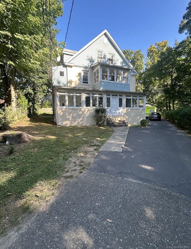 view of front facade with a sunroom