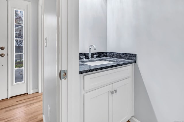 bathroom with vanity and hardwood / wood-style flooring