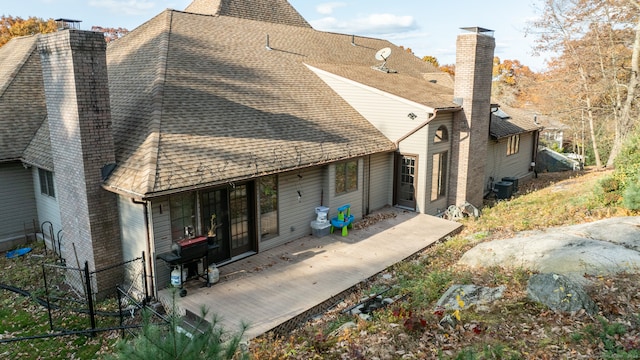 rear view of property with central air condition unit and a porch