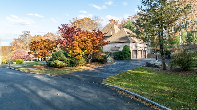 view of home's exterior featuring a yard and a garage