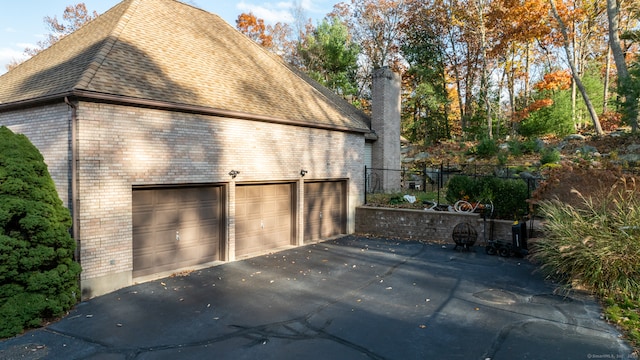 view of side of home with a garage