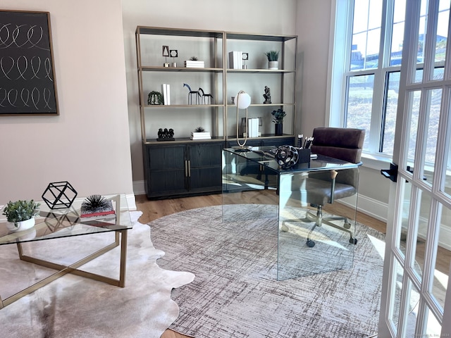 office space featuring french doors and light hardwood / wood-style floors