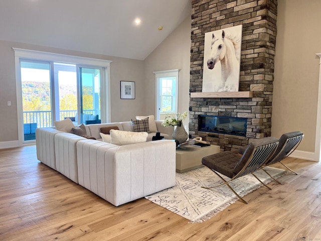 living room with plenty of natural light, a fireplace, and light hardwood / wood-style flooring