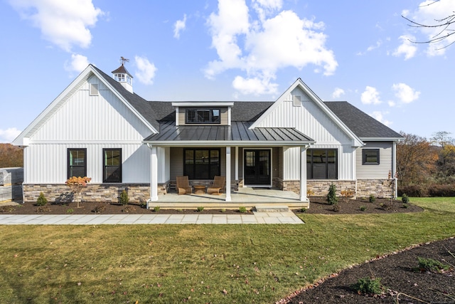 167 Willow Creek Estates Dr, Southbury, CT 06488 - view of front of house featuring a standing seam roof, stone siding, a shingled roof, and covered porch